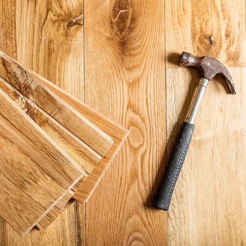 Hammer On Planks Of Hardwood Flooring
